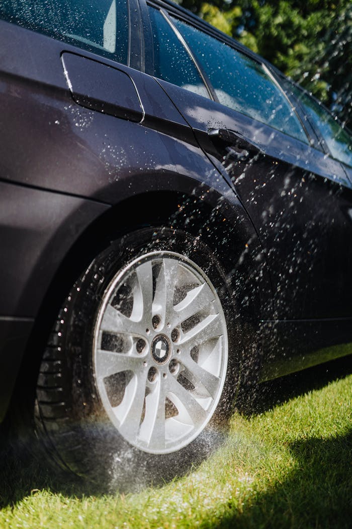 Crafting Captivating Headlines: Your awesome post title goes here A car tire being washed with water outdoors on a sunny day. Perfect for cleanliness themes.