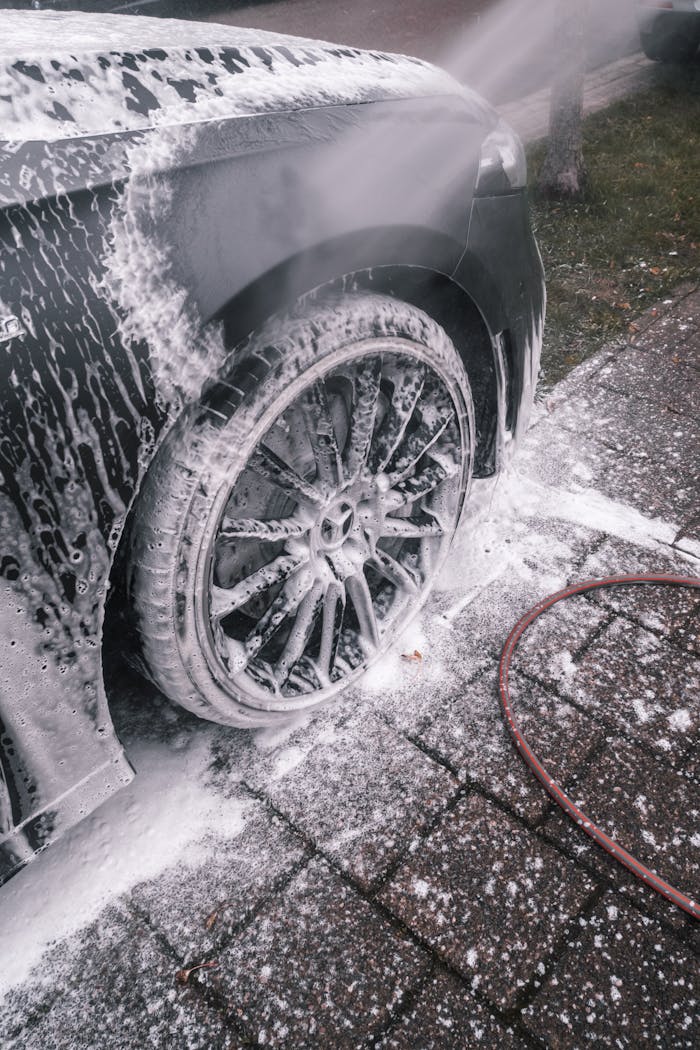 The Art of Drawing Readers In: Your attractive post title goes here Close-up of a luxury car wheel being thoroughly washed with foam outdoors.